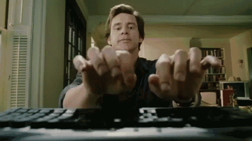 Jim Carey furiously typing on a computer
